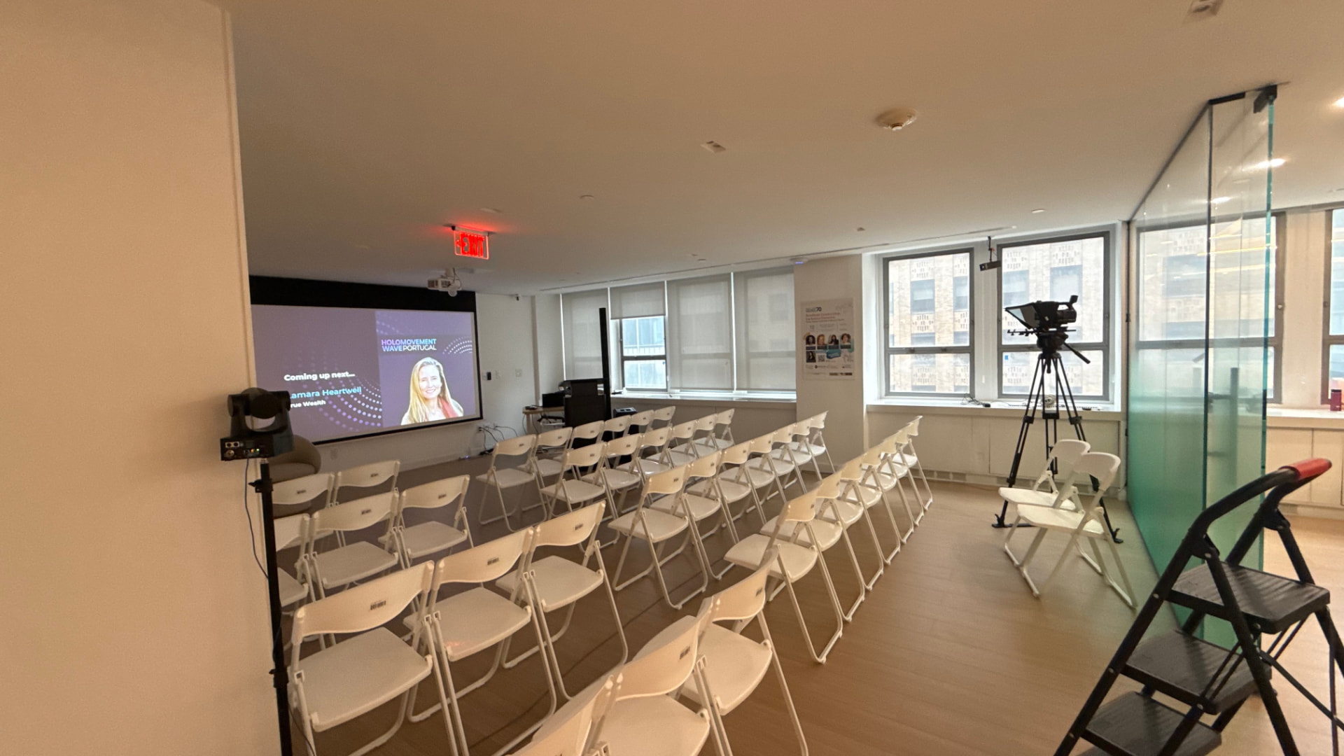 Event seating, projection screen, and studio camera set up for a livestreamed civil society session