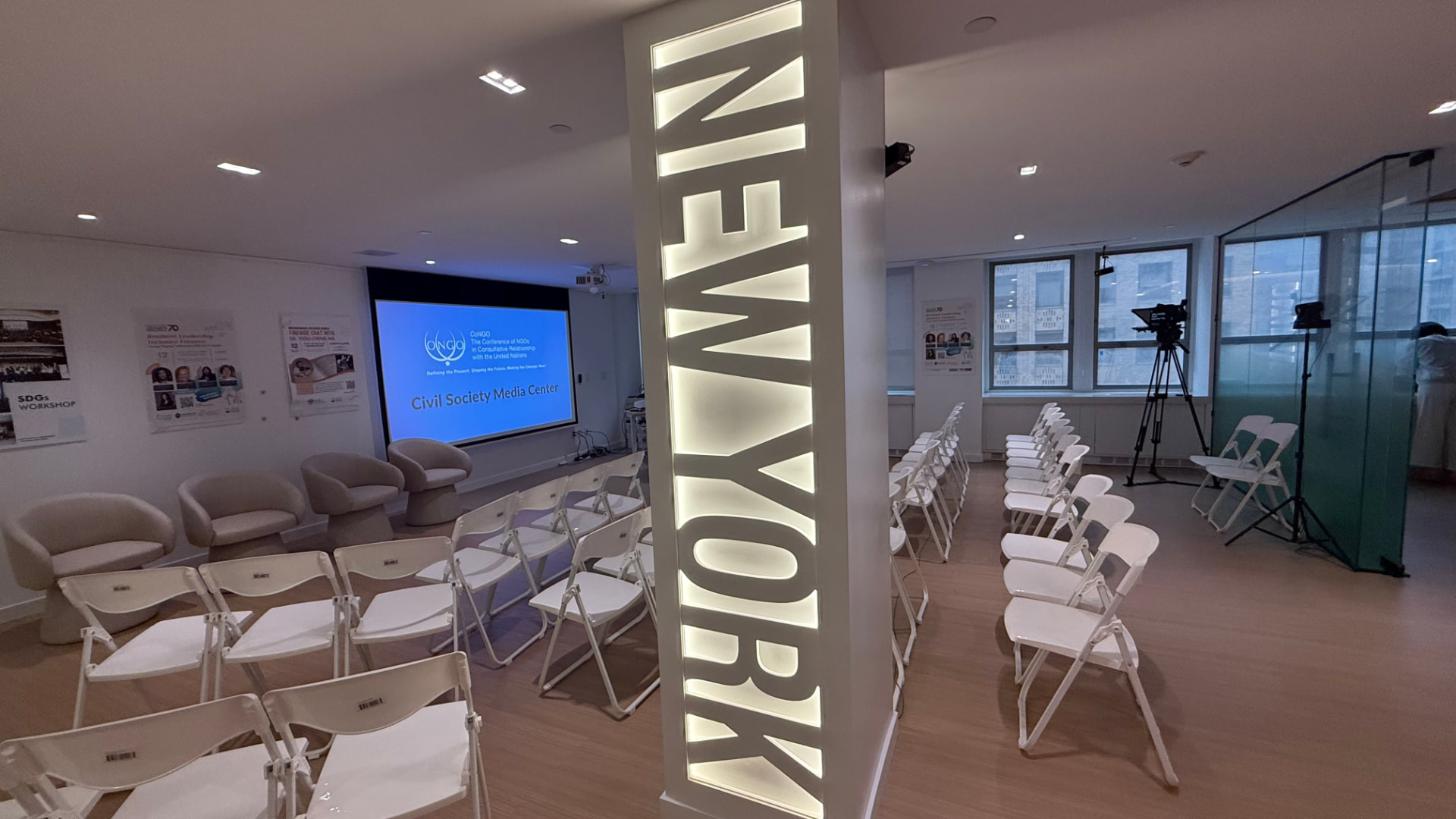 Illuminated NEW YORK signage beside rows of seating in the Civil Society Media Center